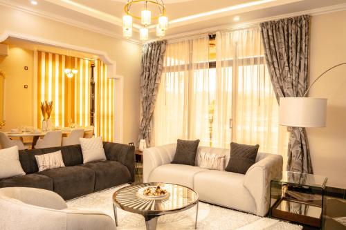 a living room with a couch and a table at Résidence La Perle - Yaoundé in Yaoundé