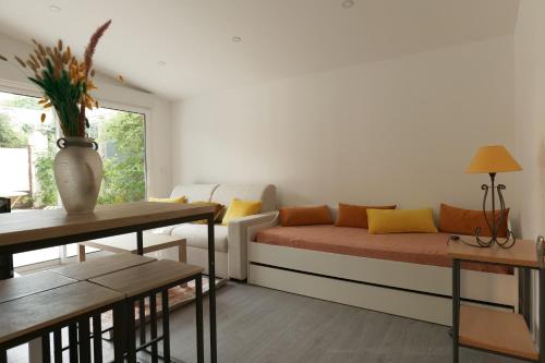 un salon avec un canapé et une table dans l'établissement Charmant studio lumineux à Chaville, à Chaville