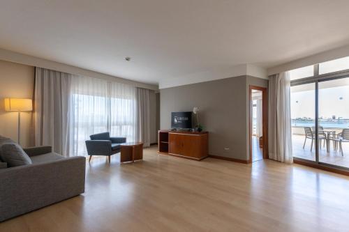 a living room with a couch and a television at Eurostars Las Salinas in Caleta De Fuste