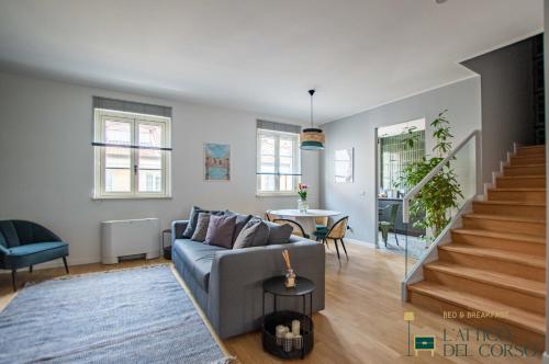 a living room with a couch and a table at L'Attico del Corso in Trieste