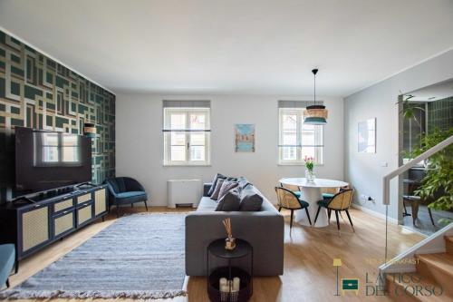 a living room with a couch and a table at L'Attico del Corso in Trieste
