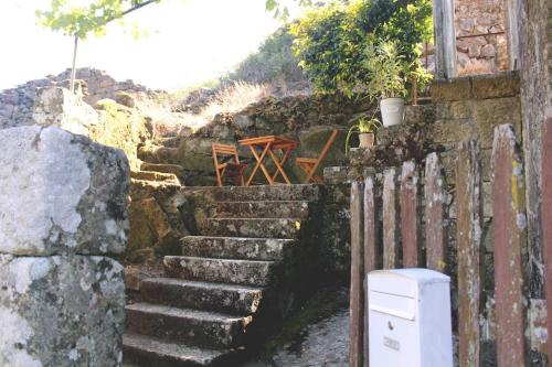 a set of stone stairs next to a building at Casa Vouzelinha in Vouzela
