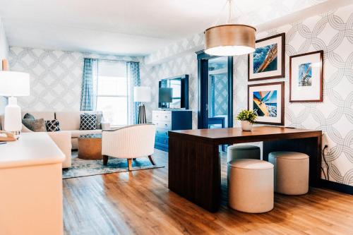 a living room with a table and some chairs at Salem Waterfront Hotel & Suites in Salem