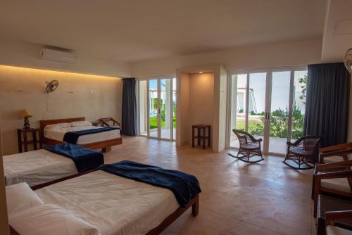 a hotel room with two beds and a balcony at 97985 Stunning beachfront Suites Wi-Fi East of Progreso in Chicxulub