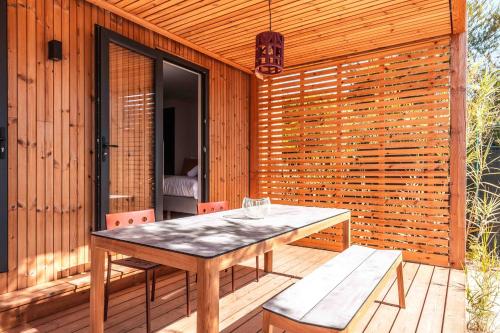 a wooden patio with a table and two chairs at Salines in Hyères