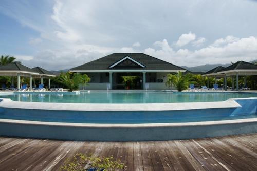 a swimming pool in front of a house at Jamnick Vacation Rentals - Fern Court, Richmond Estate, St Ann, Jamaica in Ocho Rios