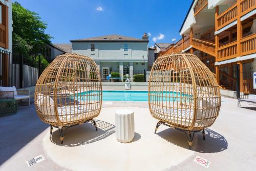 two bird cages sitting next to a swimming pool at Newly Renovated Atlanta Condo Prime Buckhead Atl in Atlanta