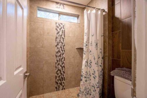 a bathroom with a shower with a shower curtain at 180 Perfect for large groups in Coachella