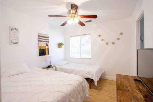a bedroom with two beds and a ceiling fan at 180 Perfect for large groups in Coachella