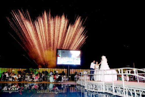 a fireworks display at a wedding reception with a large screen at Layali Al Shams Hotel in ‘Anjar