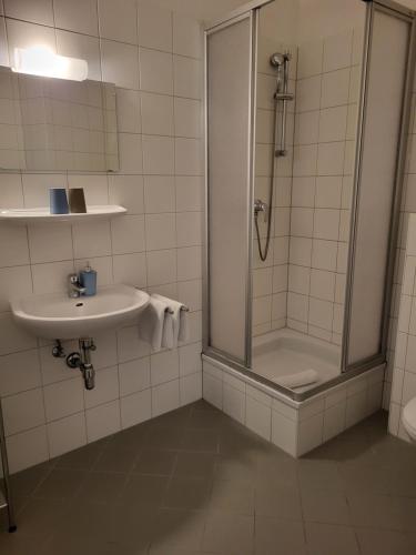 a bathroom with a shower and a sink at Hotel Alpin Murau in Murau