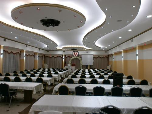 a large room with tables and chairs in it at Meka Hotel in Dragash