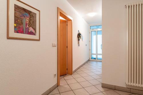 a hallway with a door and a painting on the wall at Appartments Reichegger in Villa Ottone