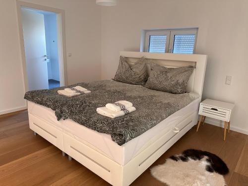 a bedroom with a bed with two towels on it at Villa Parndorf Lake 1 next to Outlet in Parndorf
