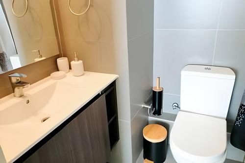 a bathroom with a toilet and a sink at Smart Host Rentals - Vive la energía de La Serena in La Serena
