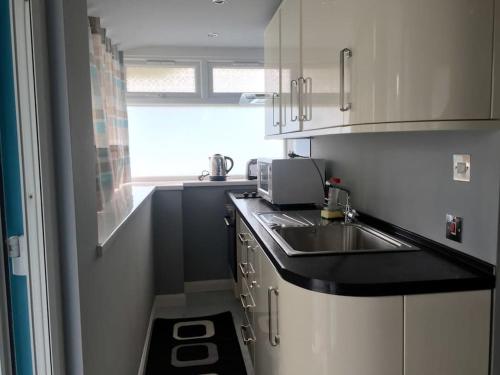 a kitchen with a sink and a counter top at Chadwich Heights in Bromsgrove
