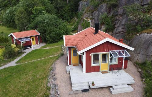 a small red and yellow house on a hill at 2 Bedroom Beautiful Home In Fjällbacka in Fjällbacka