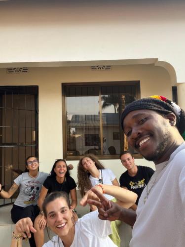 a group of people standing in front of a house at Kilimanjaro Trekcity Hostel in Moshi