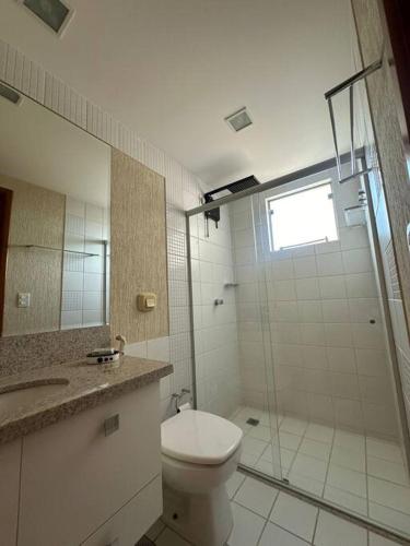 a bathroom with a toilet and a glass shower at Caldas Novas - Prive das Thermas II - Apto 3 quartos - Parque Aquático in Caldas Novas