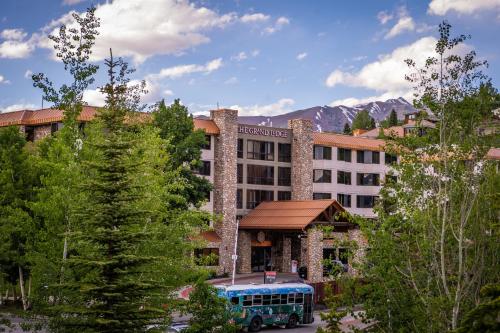 a bus parked in front of a building with a bus at The Grand Lodge Hotel and Suites in Mount Crested Butte