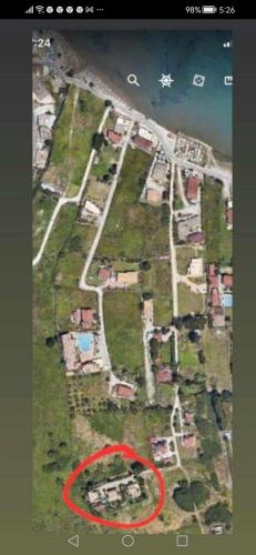 a red map of a city with houses and the ocean at Apollo Greekgod Apartments in Sidari