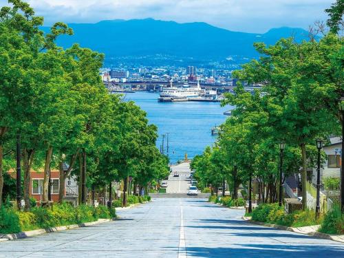 an empty street with a view of a river at Tasogare Apartment 101 in Hakodate