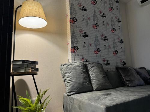 a living room with a couch and a wall with a spider pattern at The Base Condo in Pattaya Central