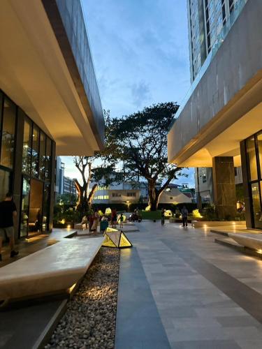 a large building with people sitting in a courtyard at The Base Condo in Pattaya Central
