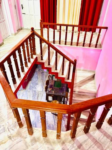 two wooden stairs with a table in the middle at Rose villa home stay in Vayittiri