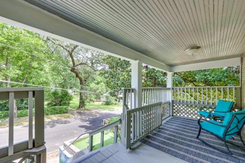 a porch with a blue chair on it at Pet-Friendly Home, Near Hot Springs National Park! in Hot Springs