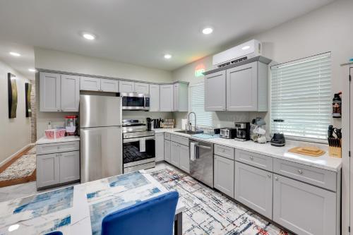 a large kitchen with white cabinets and appliances at Pet-Friendly Home, Near Hot Springs National Park! in Hot Springs