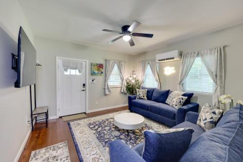 a living room with blue couches and a ceiling fan at Pet-Friendly Home, Near Hot Springs National Park! in Hot Springs