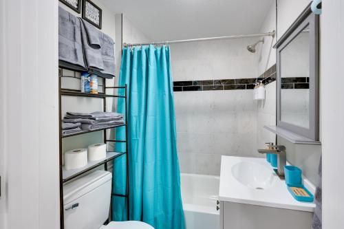 a bathroom with a blue shower curtain and a sink at Pet-Friendly Home, Near Hot Springs National Park! in Hot Springs
