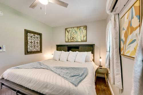a bedroom with a bed and two paintings on the wall at Pet-Friendly Home, Near Hot Springs National Park! in Hot Springs