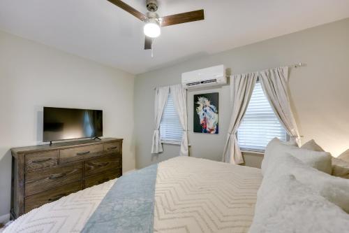 a bedroom with a bed and a flat screen tv at Hot Springs Home with Yard, Walk to Bathhouse Row! in Hot Springs