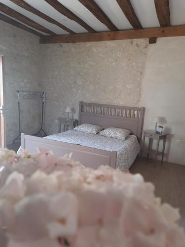 un dormitorio con una cama con dos almohadas en La Maison Genevier - Chambre Marguerite, en Montreuil-en-Touraine