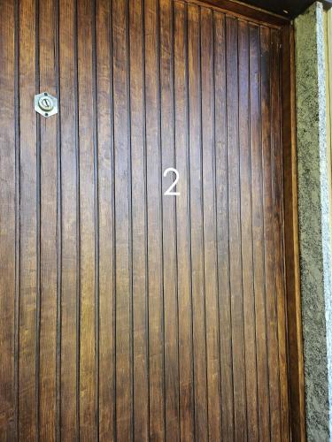 a wooden door with the number on it at San Fedele Intelvi - Starsirius Apartments in San Fedele Intelvi