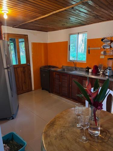a kitchen with a table with wine glasses on it at Hacienda Valencia in Santa Marta