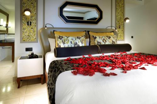 a bed with a bunch of red roses on it at The Signature Level at Grand Palladium Lady Hamilton Resort & Spa- All Inclusive in Lucea