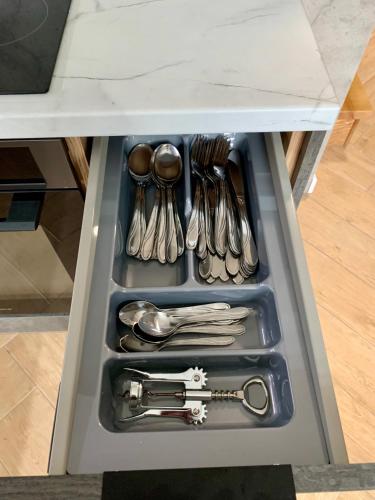 a drawer filled with silver utensils in a table at Domy Leśne Szumy na Roztoczu in Zwierzyniec