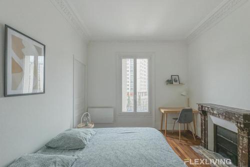 a white bedroom with a bed and a fireplace at Flexliving - Room - Henri Sellier - Suresnes 92 in Suresnes