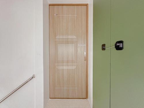 a wooden door in a hallway next to a shower at 4 bed 3 room near Gimpo airport in Seoul