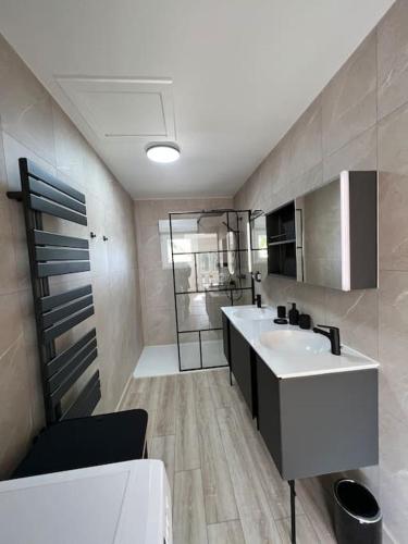 une salle de bain avec un lavabo blanc et une douche dans l'établissement Charmante maison a la campagne, à Roussas