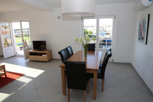 a dining room with a table and chairs at Exclusive new apartment in Tavira in Tavira