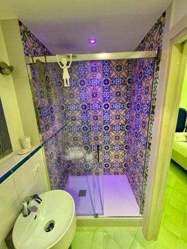 a bathroom with a shower with a toilet and a sink at Vesuvio View in Vico Equense