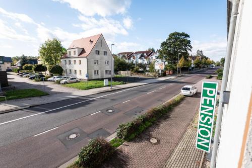 a view of a street with a sign on a building at Pension Greiser in Leipzig