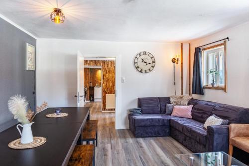 a living room with a couch and a table at Feichtenhäusl app 2 in Westendorf