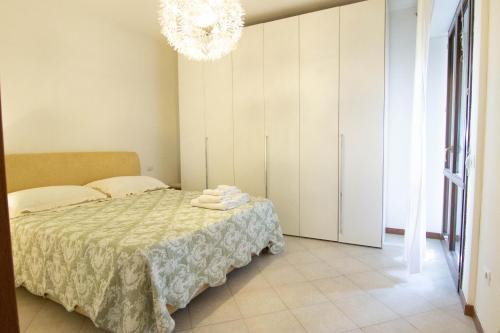 a bedroom with a bed and a chandelier at Daniel's House in Pontedera