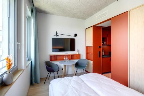 a bedroom with a bed and a table and chairs at DEIN APART München in Munich