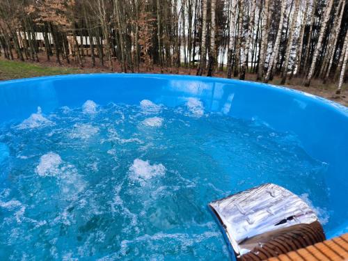 a pool of blue water with snow in it at Przystań Jeziorany - willa nad jeziorem - Warmia i Mazury in Jeziorany